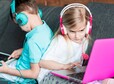 thumb two kids couch with laptop